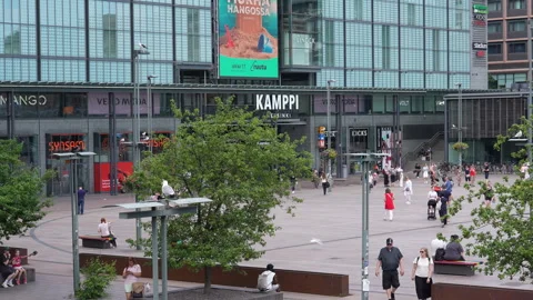 People at Narinkka Square in front of Kamppi shopping centre in Helsinki Stock Footage 340559211