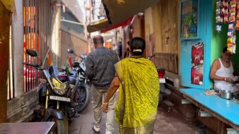 People navigating through the narrow lanes of Varanasi Stock Footage 284496327