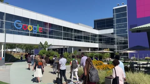 People near the Googleplex headquarters complex of Google Stock Footage 254197637