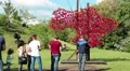 People near map of Ukraine decorated red flowers HD Footage