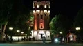 People near old water tower at night time in Vinnytsia city, Ukraine HD Footage