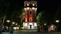 People near old water tower at night time in Vinnytsia city, Ukraine HD Footage
