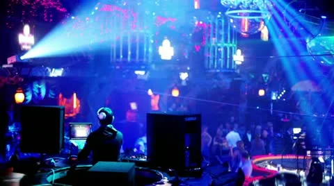 People in night club with illumination, dj on workplace Stock Footage