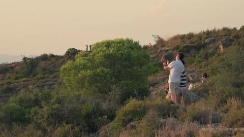 People observing a total solar eclipse from a mountain in Sagunto Stock Footage 342277914