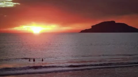People in ocean by Sunset 1 Stock Footage 10785655