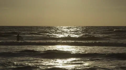 People in the ocean at sunset 스톡 동영상 32702868