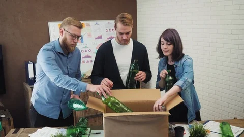 People in office putting plastic garbage in recycling bin Stock Footage 95618477