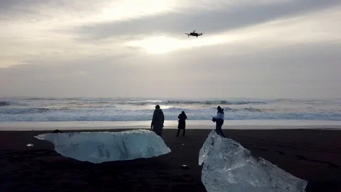People operating a drone on the diamond beach in Iceland Stock Footage 106205278