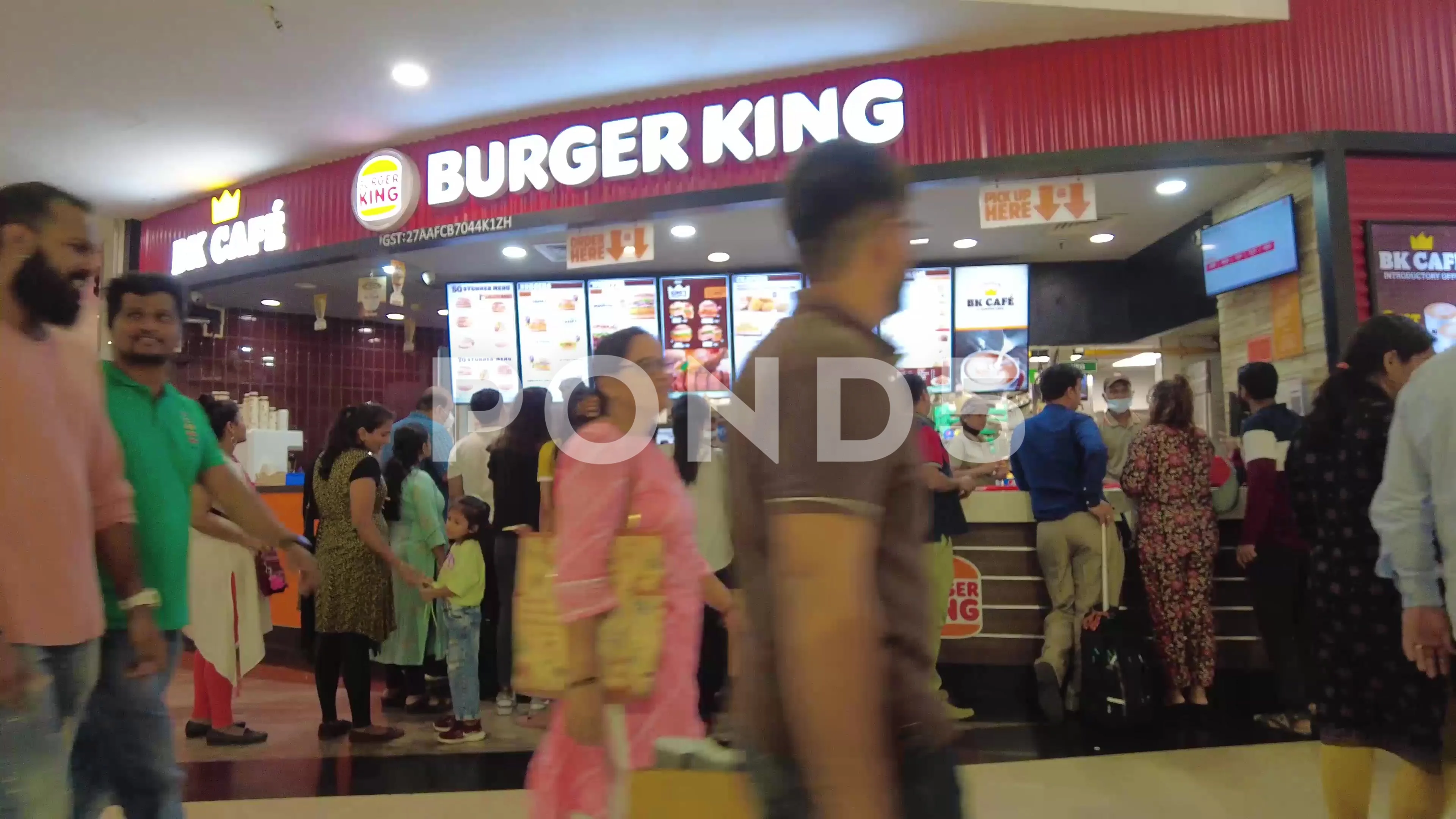 People order at Burger King eat-in or takeout fast food restaurant counter.