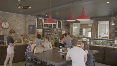 People Ordering and Socializing in a Busy Sydney Cafe with Rustic Interior Decor Stock Footage 345666135