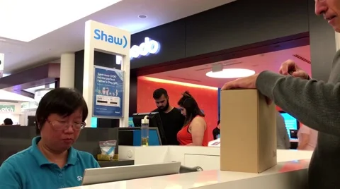 People ordering service at shaw booth and clerk typing information Stock Footage 64910582