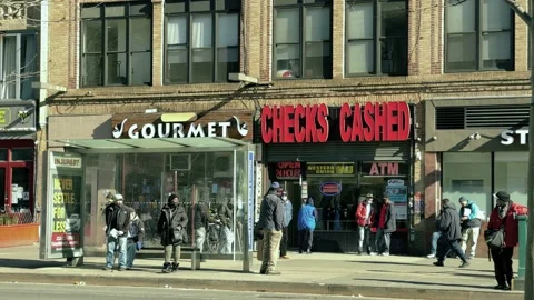 People outside checks cashed sign Harlem 125th street winter New York City NYC 库存影片 149440212