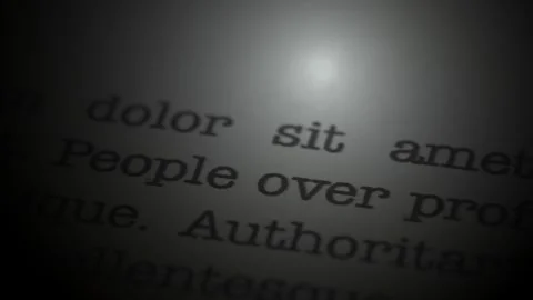 People over profit. Moving text printed on a page. Slow motion. Stock Footage 307286181