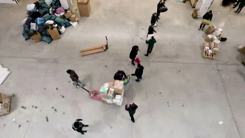 People pack and sort humanitarian aid for refugees Video stock 204071154