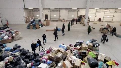 People pack and sort humanitarian aid for refugees Stock Footage 204071164
