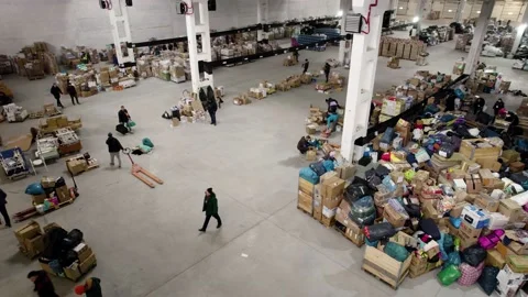 People pack and sort humanitarian aid for refugees Stock Footage 204071594