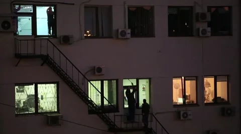 People paint from the window frame. Night. Stock Footage 56646171