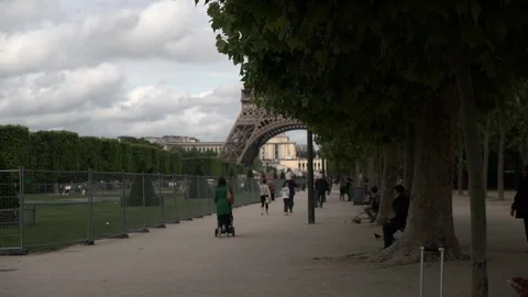People in park by Eiffel Tower Stock Footage 125807628