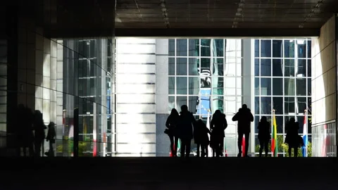 People pass through the arch of a large glass Stock Footage 93188610