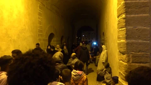 People pass through arched passage of Bab Doukkala, Essaouira Stock Footage 190509249