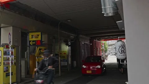 People pass under an elevated railway track in Umeda, Osaka on June 4, 2020. Stock Footage 133859285