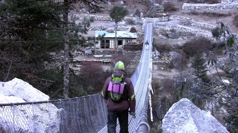 People passing the bridge over the Dudh Koshi river. Punki tenga vilage. Nepal Stock Footage 43743045