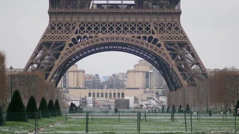 People passing by the Eiffel tower in Paris on a snowy day Stock Footage 317102717