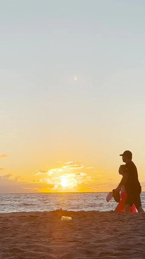 People passing at sunset, in the background sea and beach sand Stock Footage 248584959