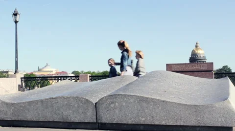 People Passing by  Symbol of Knowledge - Stone Monument Book Stock Footage 65857165