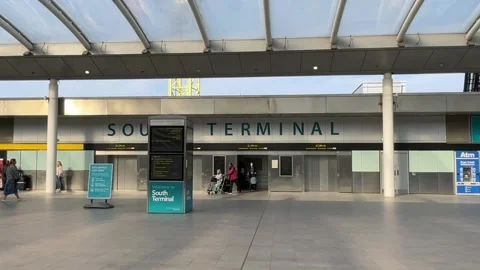 People passing through the entry of the South terminal of London Gatwick airport Stock-Footage 183885447