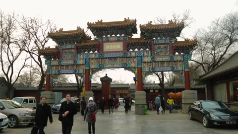 People Passing Through Main Gate of Lama Temple in Beijing with Cars Parked Stock Footage 345828415
