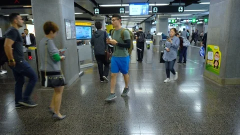 People passing through modern check gate turnstiles in underground mtr metro Stock Footage 92044954