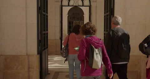 People passing through an open door Stock Footage 254006623