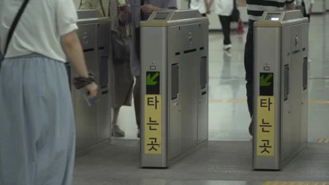 People passing through subway ticket gates in Seoul Stock Footage 332644019