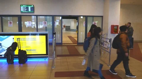 People passing through the turnstiles. Exit to the City in Treviso, Italy. Stock Footage 76160738