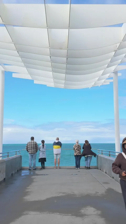 People on a pier under a modern canopy, Marine Parade, Napier, New Zealand Stock-Footage 332967962