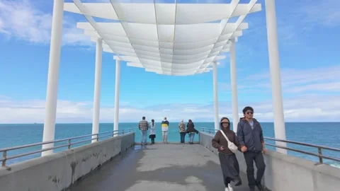 People on a pier under a modern canopy, Marine Parade, Napier, New Zealand Video stock 333166372