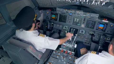 People piloting a plane in a simulator, top view. 库存影片 97959524