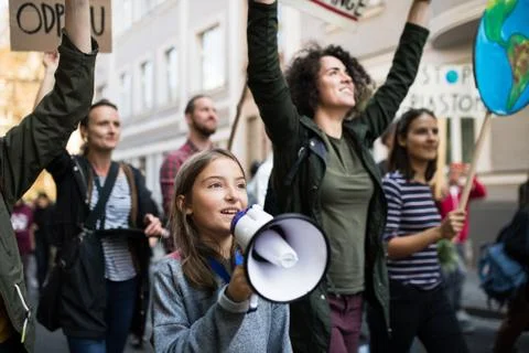 People with placards and amplifier on global strike for climate change. Stock Photos
