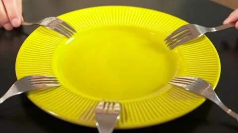 People placing forks around an empty plate. Stock Footage 332930814