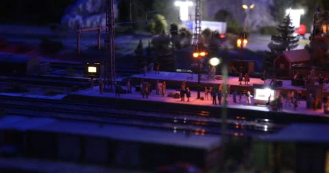 People on the platform expect the train to arrive at night Stock Footage 102475565