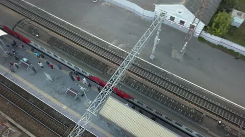 People on the platform, a passenger train is approaching, top view. Stock Footage 145932811