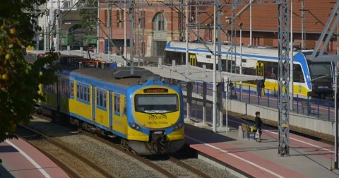 People at the Platform Two Blue And Yellow Passenger Electric Trains are Stock Footage 55294658