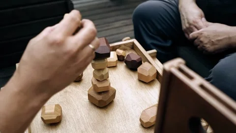 People play a board game at a table while sitting at a team building table Stock Footage 341677019