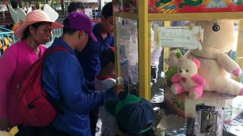 People play at a game machine at the Dainam amusement park, Vietnam Stock Footage