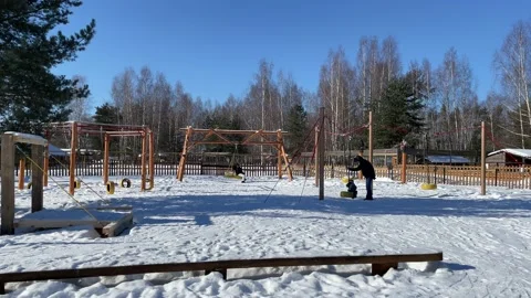 People on the playground in winter Stock Footage 172094590
