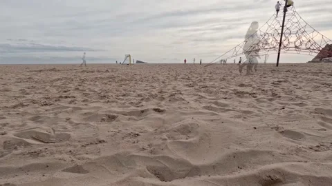 People playing and walking along the west beach of Benidorm Stock Footage 227193192