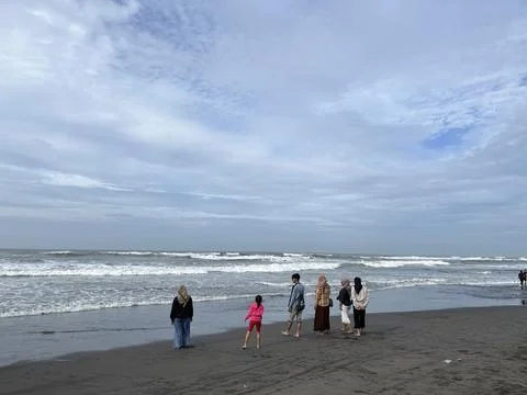 People playing on the beach with panoramic view of the sea Stock Photos