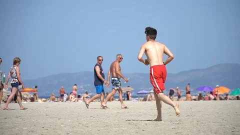 People playing at the beach slow motion Stock Footage 128349819