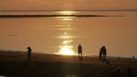 People playing on the beach at sunset Stock-Footage 78097219
